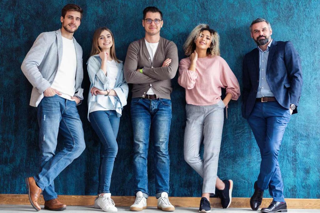 Young people standing in a row smiling