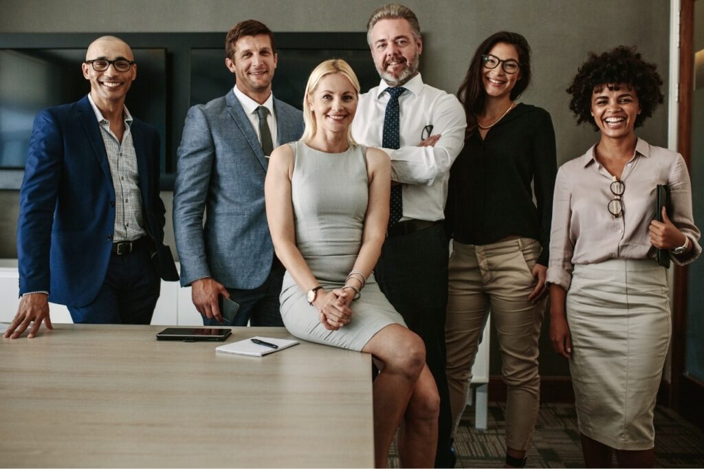 A group of solicitors from a law firm smiling and posing for the camera.