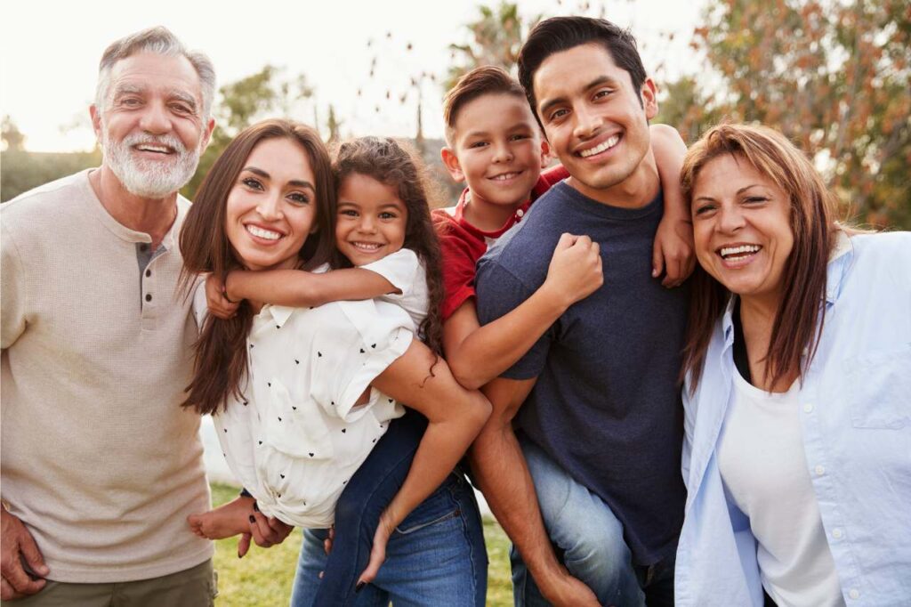 Family group with parents, children and grandchildren all smiling.