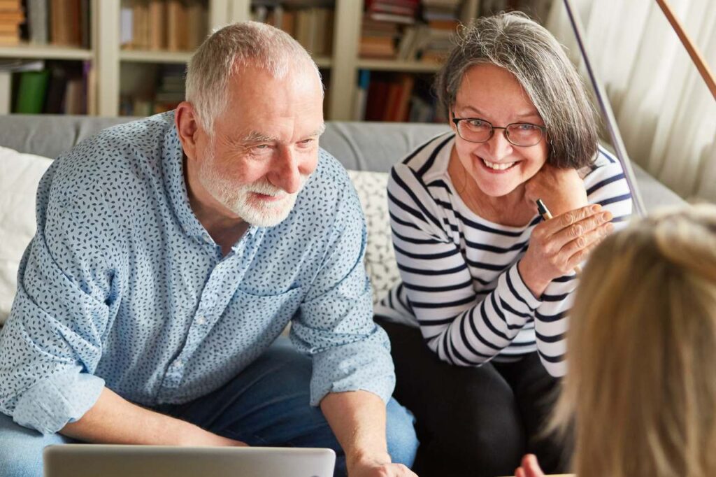 Couple talking to their financial adviser about retirement planning.
