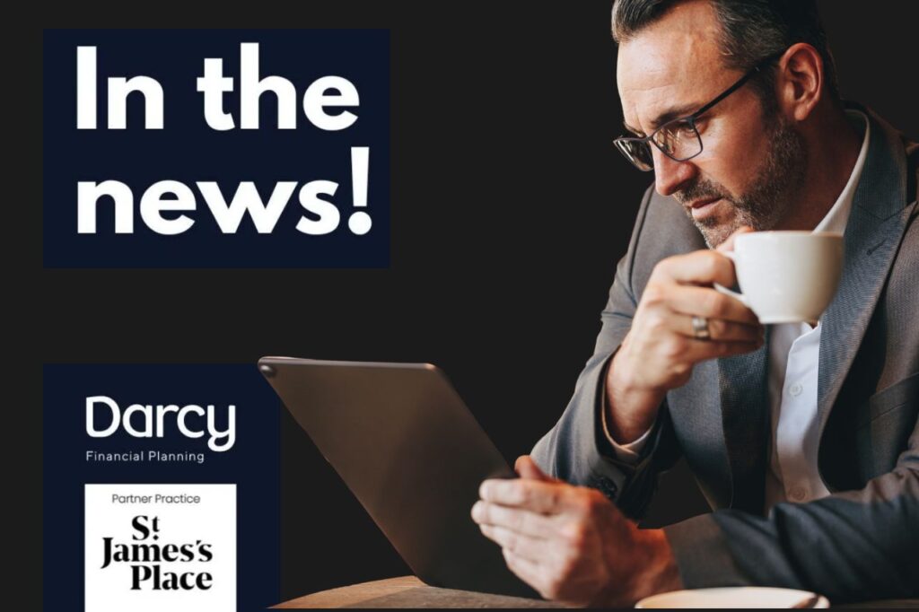 Man in a suit reading the news on his iPad while drinking coffee.